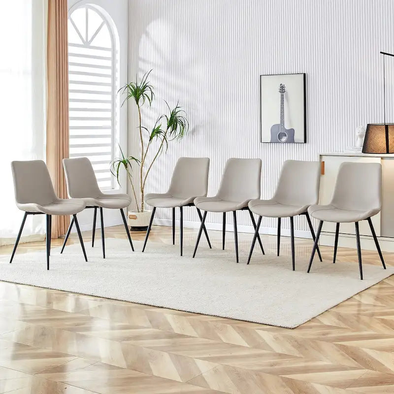 Ensemble de 4 chaises de restaurant rembourrées avec dossiers en daim et pieds en métal noir, convenant aux cuisines, salons et maisons de campagne.